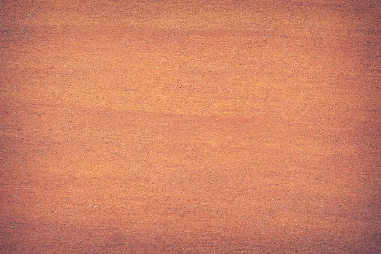 Vibrant orange textured surface, perfect for design backdrops and creative projects.